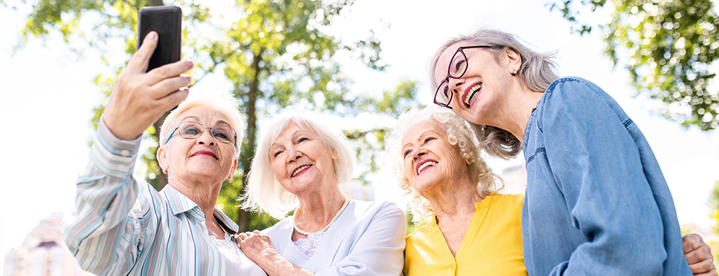 Image of four senior women taking a selfie photo together